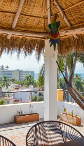 Palapa rooftop terrace with hammock and ocean view in Bucerías